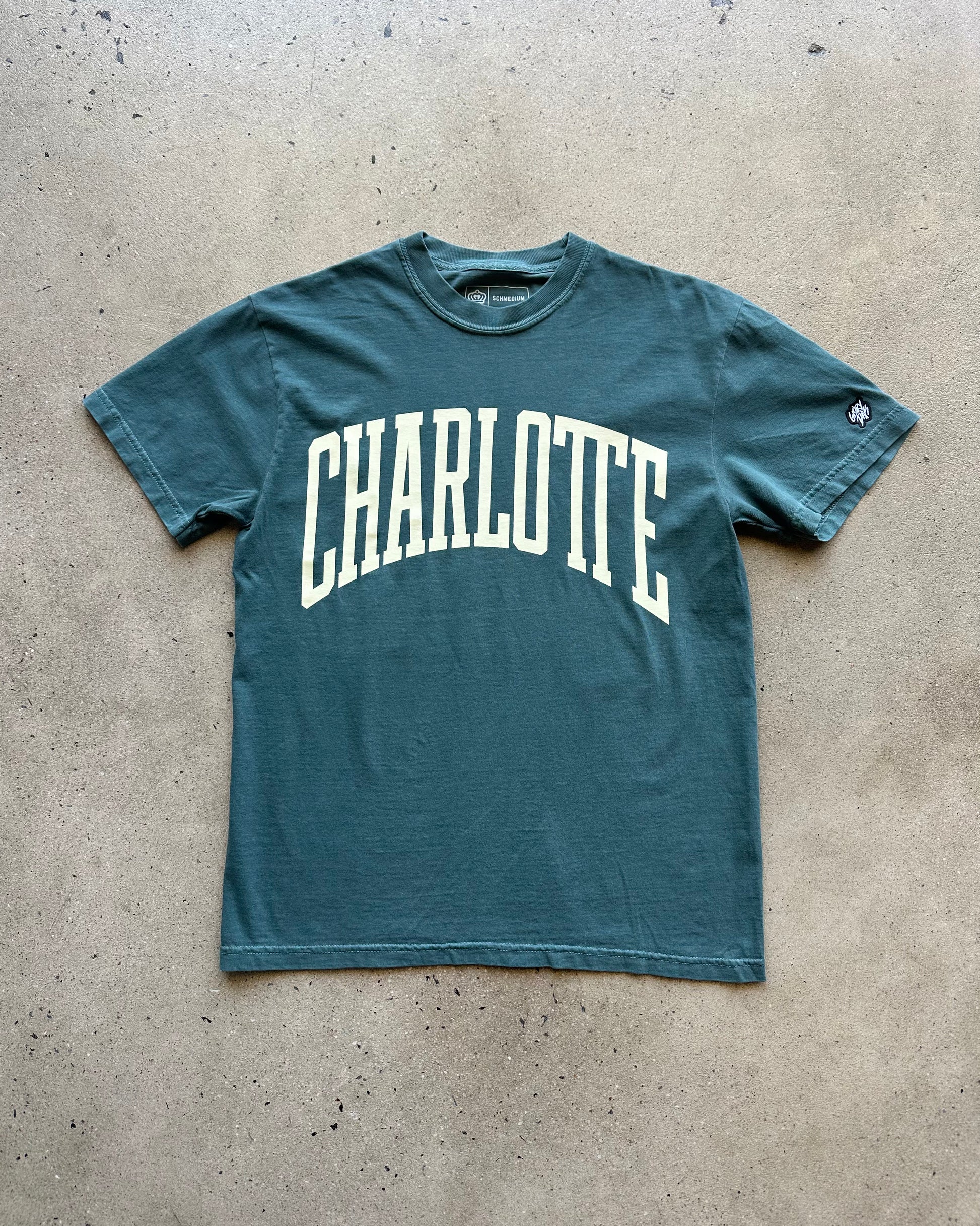Green t-shirt with 'Charlotte' printed on it